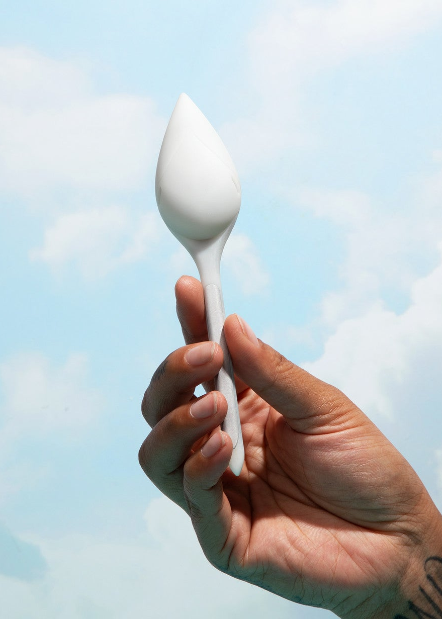 Image of A bright sky with clouds as the background to a hand holding leaflet plant sensor. 